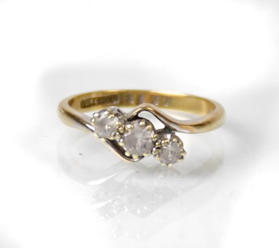 Lot 825 - A 9ct yellow gold ring set with three white...