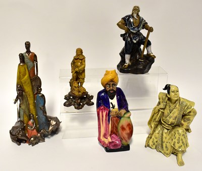 Lot 231 - A small mixed group of figures comprising a...