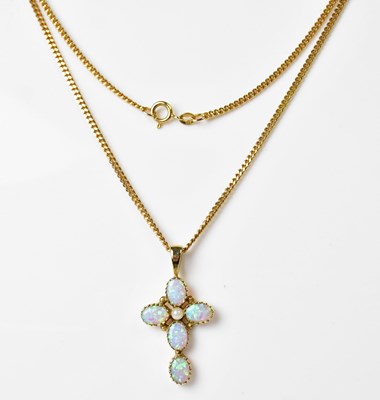 Lot 902 - A 9ct yellow gold cross, set with five...