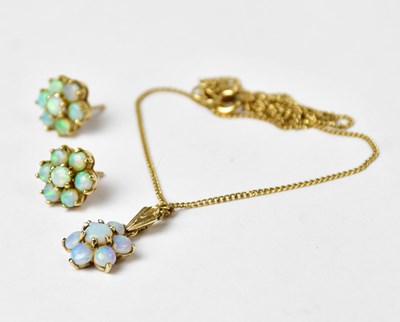 Lot 893 - A 9ct yellow gold cluster pendant set with...
