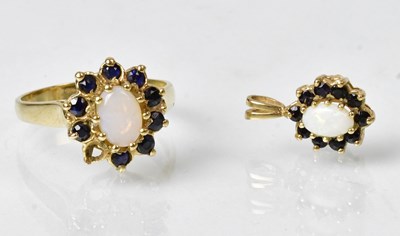 Lot 895 - A 9ct yellow gold cluster pendant, set with...