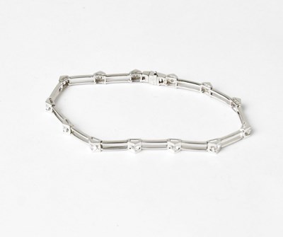Lot 849 - An 18ct white gold tennis bracelet with open...