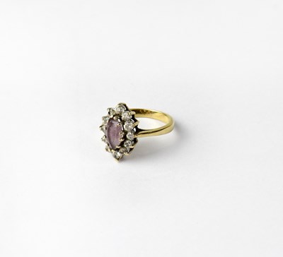 Lot 958 - A 9ct yellow gold dress ring set with pale...