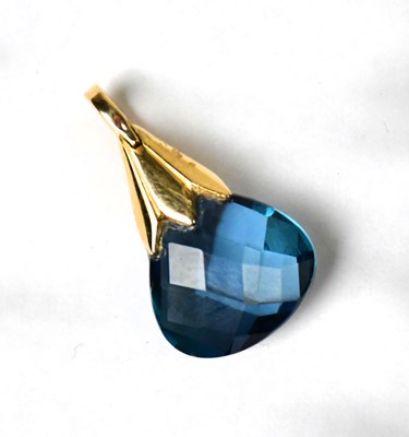 Lot 918 - A yellow metal pendant set with a facet cut...