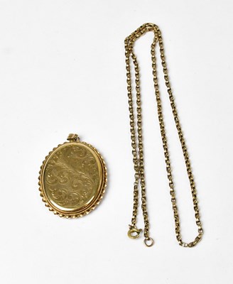 Lot 900 - A 9ct yellow gold oval locket withy engraved...