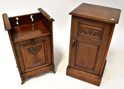 Lot 23 - An Arts and Crafts oak purdonium with carved...