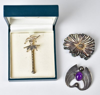 Lot 887 - Three silver brooches, comprising a jester...