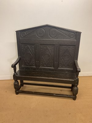 Lot 254 - A Victorian carved dark oak high back settle,...