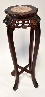 Lot 134 - A Chinese carved hardwood jardinière stand...