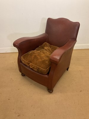 Lot 264 - A French leatherette club chair, raised on bun...