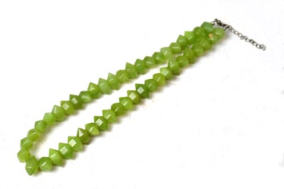 Lot 928 - A jade necklace with faceted beads, with a...