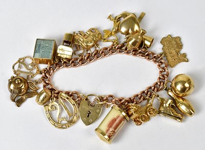 Lot 857 - A 9ct rose gold curb link charm bracelet, the...