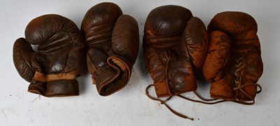 Lot 688 - Two pairs of vintage leather boxing gloves.