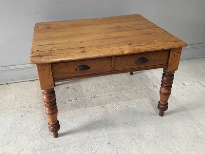 Lot 108 - A pine table with two drawers, on turned legs,...
