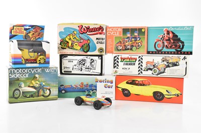 Lot 1415 - A collection of eight boxed tinplate toys...