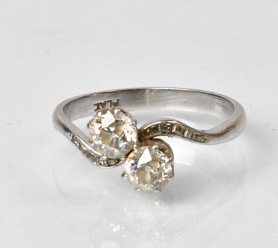 Lot 775 - A platinum ring with two diamonds on...