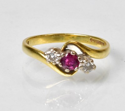 Lot 807 - An 18ct gold ring with a ruby flanked a pair...