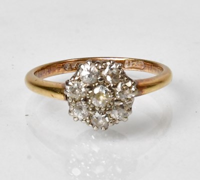 Lot 806 - An 18ct yellow gold ring with nine diamonds in...