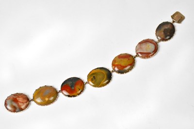Lot 870 - A yellow metal bracelet set with seven oval...