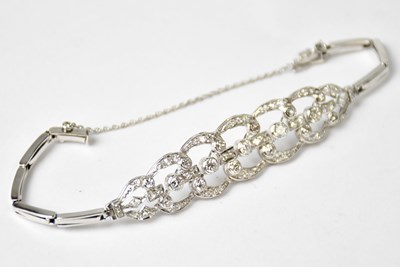 Lot 869 - A white metal articulated bracelet set with...