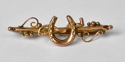 Lot 880 - A 9ct gold bar brooch with rose gold horseshoe...
