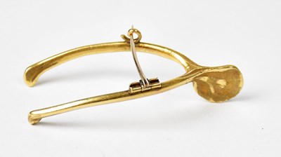Lot 886 - A yellow metal brooch in the form of a...