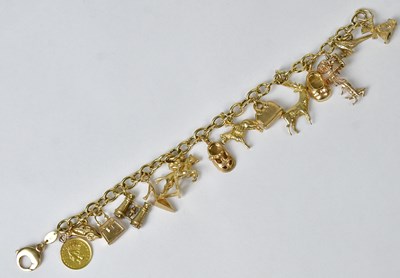Lot 856 - A 9ct gold charm bracelet, some charms stamped...
