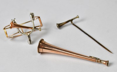 Lot 990 - A scarf ring with a horses' bit and bugle, a...