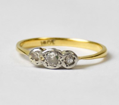 Lot 809 - An 18ct yellow gold ring with three diamonds...