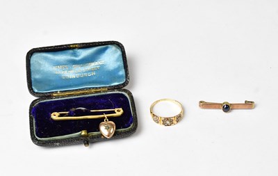 Lot 945 - A 15ct gold ring set with three diamonds on a...