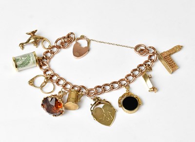 Lot 855 - A 9ct yellow curb link charm bracelet set with...