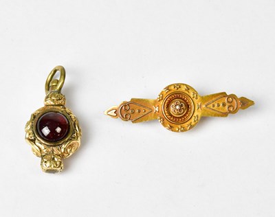 Lot 875 - A Victorian 15ct gold bar brooch with central...