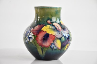 Lot 1189 - WALTER MOORCROFT; a baluster shaped vase in...