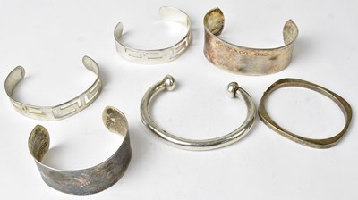Lot 872 - Six silver bracelet and bangles of various...