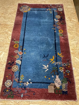 Lot 232 - An Oriental style rug decorated with blossom...