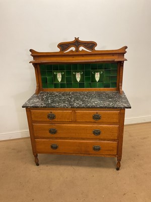 Lot 288 - An Edwardian Art Nouveau oak washstand with...