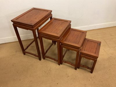 Lot 296 - A nest of four hardwood tables, largest 66 x...