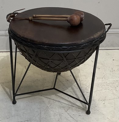 Lot 1435 - An African animal skin drum, on wrought iron...