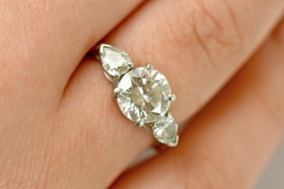 Lot 450 - A platinum diamond three stone ring, the round...
