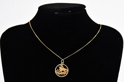 Lot 359 - A yellow metal circular pendant set with a...