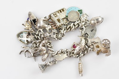 Lot 725 - A hallmarked silver curb link bracelet, set...