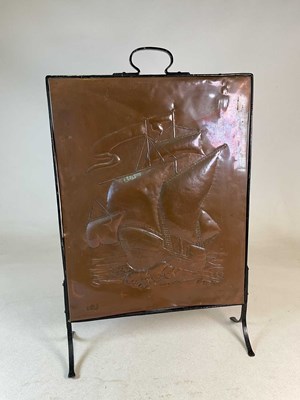 Lot 89 - An Arts & Crafts embossed copper fire screen,...