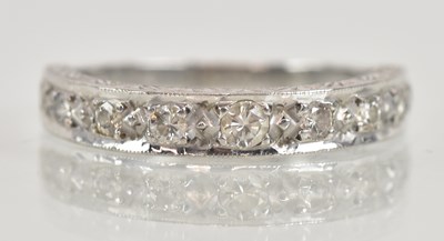 Lot 1225 - An 18ct white gold diamond set half eternity...