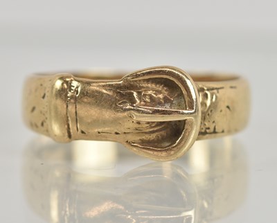 Lot 1251 - A yellow metal ‘buckle’ band ring, size W,...