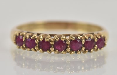 Lot 1277 - A 9ct yellow gold garnet set seven stone ring,...