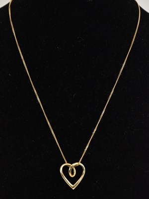 Lot 1338 - A 9ct yellow gold heart shaped pendant,...