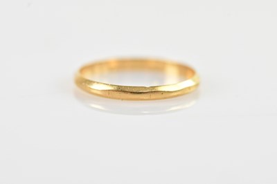 Lot 360 - A yellow metal wedding band, stamped 'AK',...