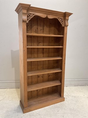 Lot 105 - A pine bookcase with five fixed shelves,...