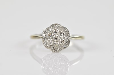 Lot 559 - A white metal diamond set daisy cluster ring,...