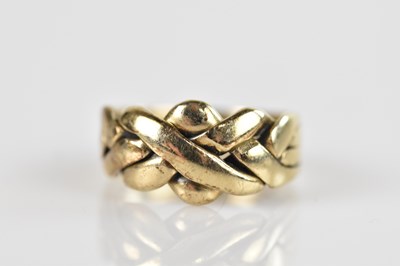 Lot 675 - A yellow metal puzzle ring, stamped '9ct',...